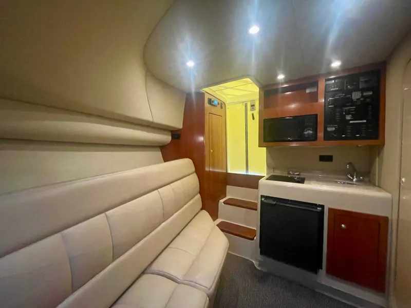 Slide: The Image of Interior of 2006 Rampage 30 Offshore boat with seating, kitchenette, and modern amenities. - 35