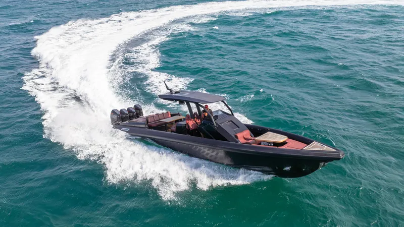 Slide: The Image of 2023 Skipper-BSK 42 boat cruising on open water, creating a dynamic wake. - 27