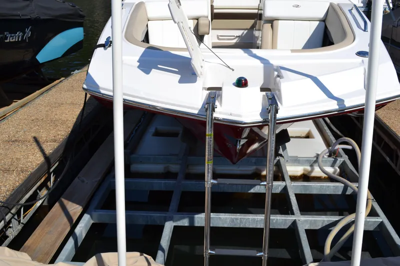 Slide: The Image of 2013 Regal 24 FasDeck boat docked with ladder and seating area visible. - 10