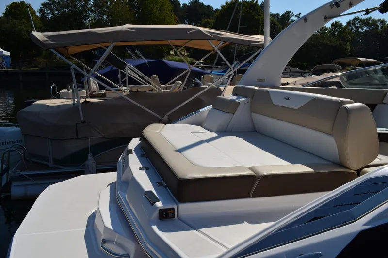 Slide: The Image of 2013 Regal 24 FasDeck boat with spacious seating at a marina. - 16