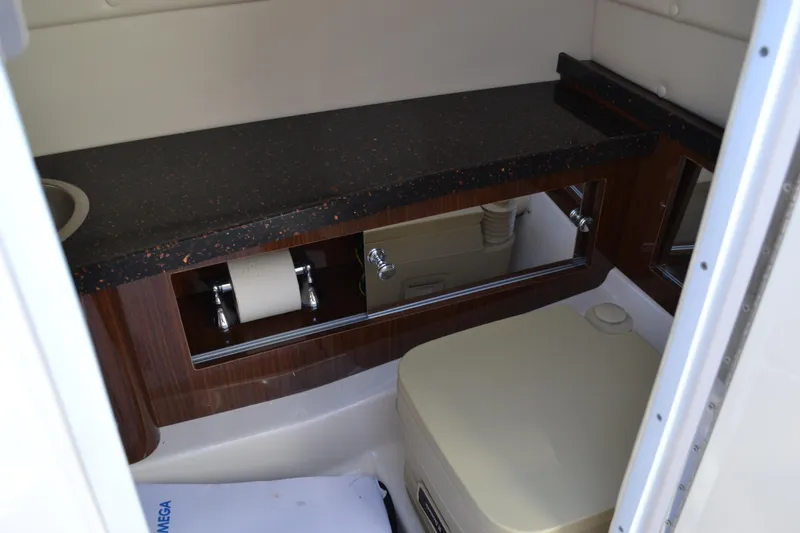 Slide: The Image of 2013 Regal 24 FasDeck boat interior with compact bathroom amenities. - 24