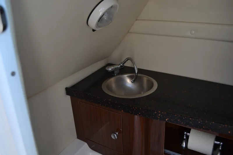 Slide: The Image of 2013 Regal 24 FasDeck boat interior with sink and storage cabinet. - 25