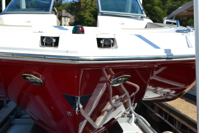 Slide: The Image of 2013 Regal 24 FasDeck boat with red hull and sleek design. - 6