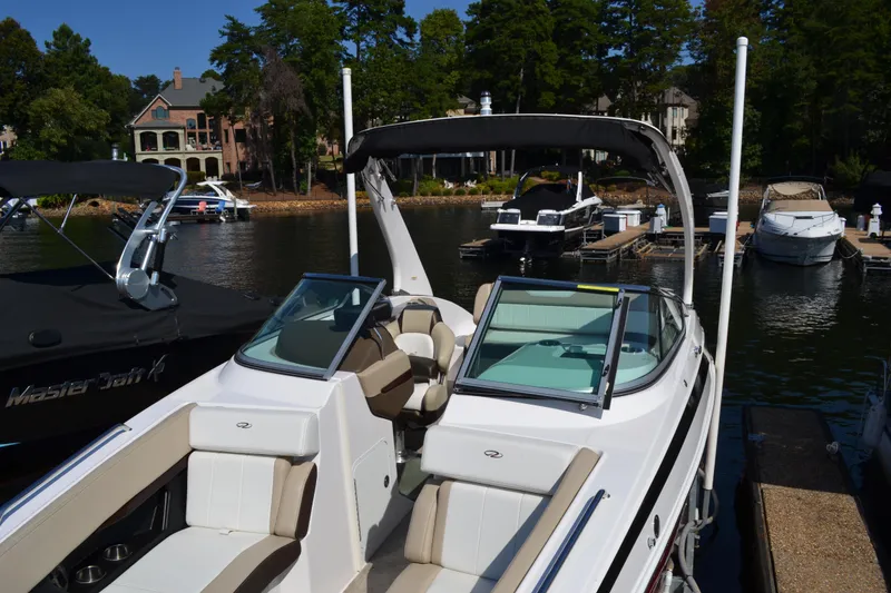 Slide: The Image of 2013 Regal 24 FasDeck boat docked at a scenic lakeside marina. - 9