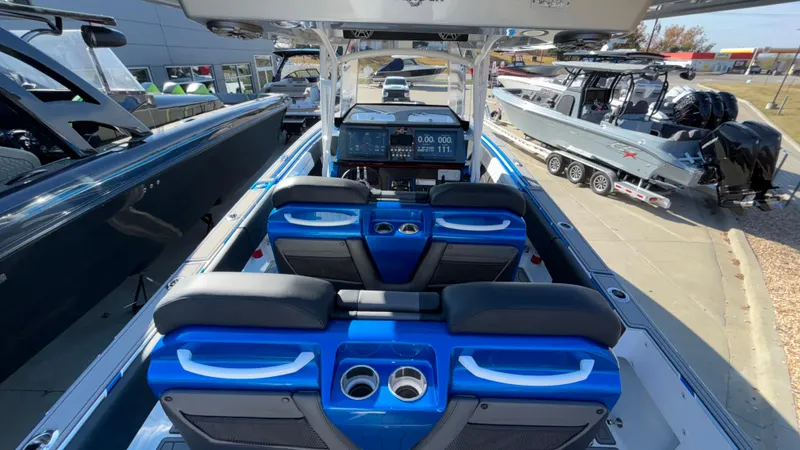 Slide: The Image of 2021 Fountain 34 SC boat interior with blue seating and modern dashboard. - 10