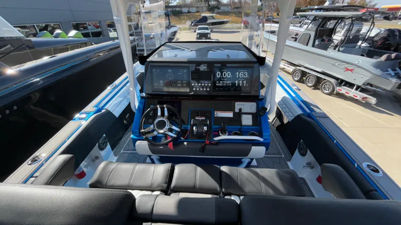 Slide: The Image of 2021 Fountain 34 SC boat cockpit with modern navigation system and seating. - 11