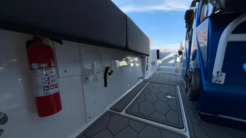 Slide: The Image of 2021 Fountain 34 SC boat interior with seating and fire extinguisher. - 13