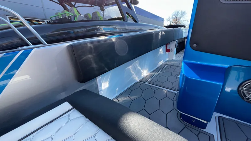 Slide: The Image of 2021 Fountain 34 SC boat interior with modern seating and hexagonal flooring design. - 17