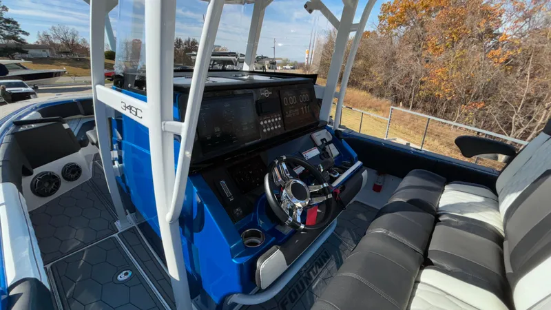 Slide: The Image of 2021 Fountain 34 SC boat interior with modern dashboard and seating. - 19