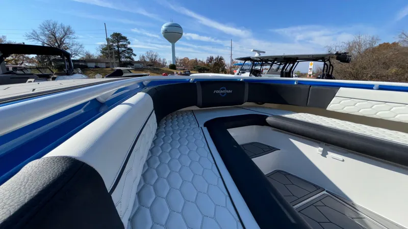 Slide: The Image of 2021 Fountain 34 SC boat interior with white and black seating, hexagonal pattern. - 21
