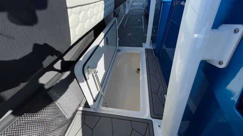 Slide: The Image of 2021 Fountain 34 SC boat interior with open storage compartment. - 29