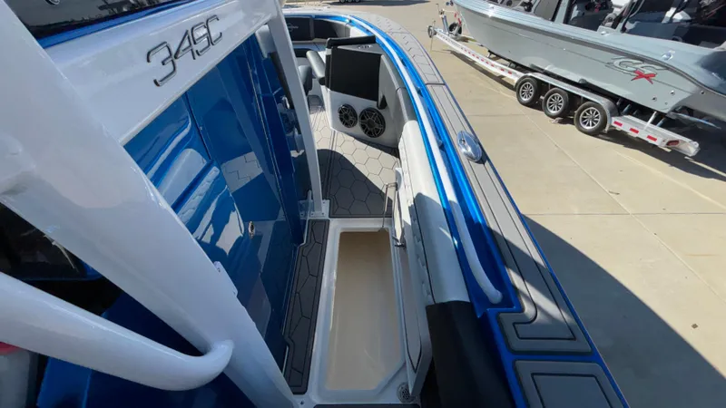 Slide: The Image of 2021 Fountain 34 SC boat interior with blue accents and storage compartment. - 30