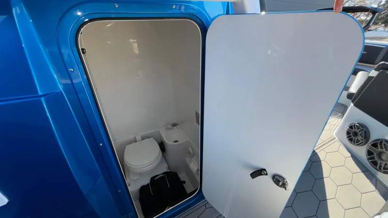 Slide: The Image of 2021 Fountain 34 SC boat interior with open bathroom door. - 31