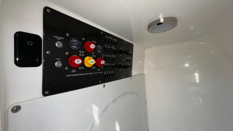 Slide: The Image of Control panel of 2021 Fountain 34 SC boat with switches and indicators. - 32