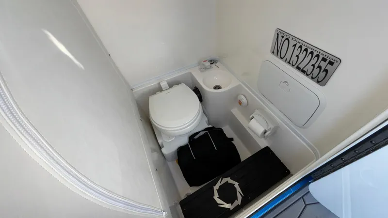 Slide: The Image of Compact bathroom in 2021 Fountain 34 SC boat with toilet and storage. - 34