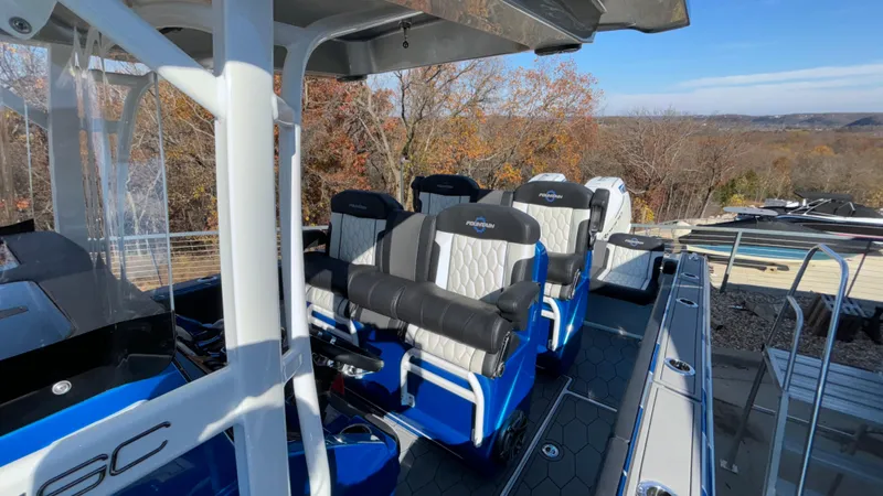 Slide: The Image of 2021 Fountain 34 SC boat interior with blue and white seating, outdoor setting. - 9