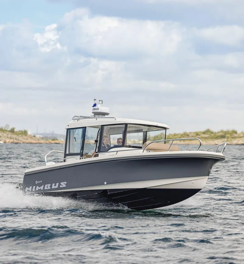 Slide: The Image of 2024 Nimbus C8 boat cruising on open water under a cloudy sky. - 19