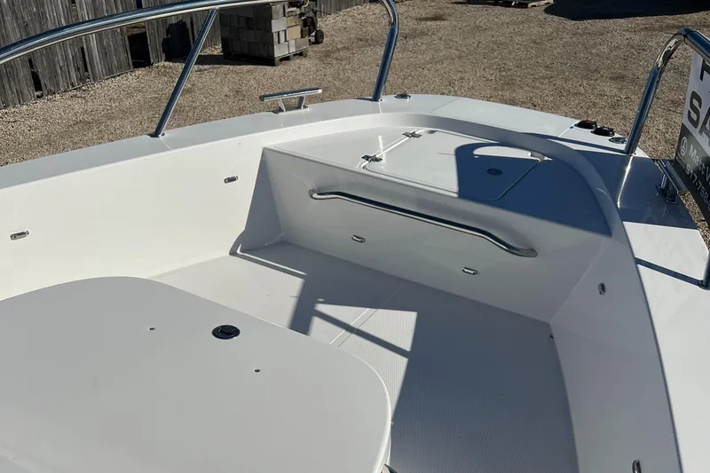 Slide: The Image of 2024 Nimbus C9 boat deck with seating and railing in sunlight. - 12