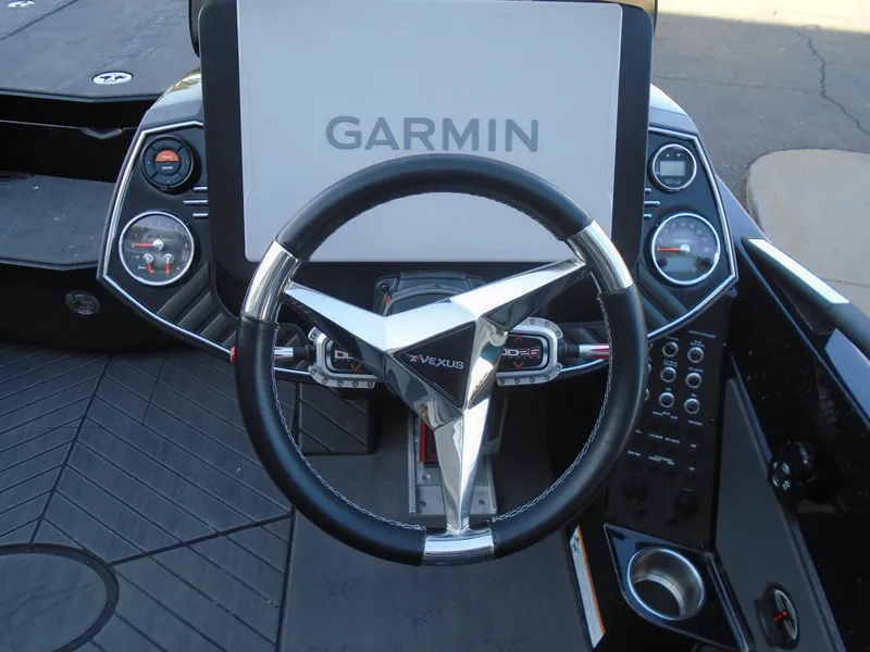 Slide: The Image of 2022 Vexus VX21 boat dashboard with Garmin navigation system and sleek steering wheel. - 9