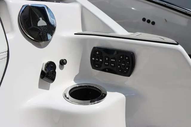 Slide: The Image of 2024 Yamaha Boats 252SD dashboard with control panel and cup holder. - 7