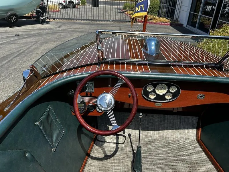 Slide: The Image of 1994 Hacker-Craft 26' Runabout interior with wooden dashboard and red steering wheel. - 5