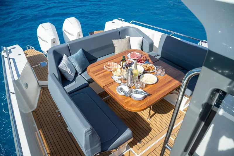 Slide: The Image of Luxurious 2024 Nimbus Tender 11 yacht with elegant dining setup on deck. - 16