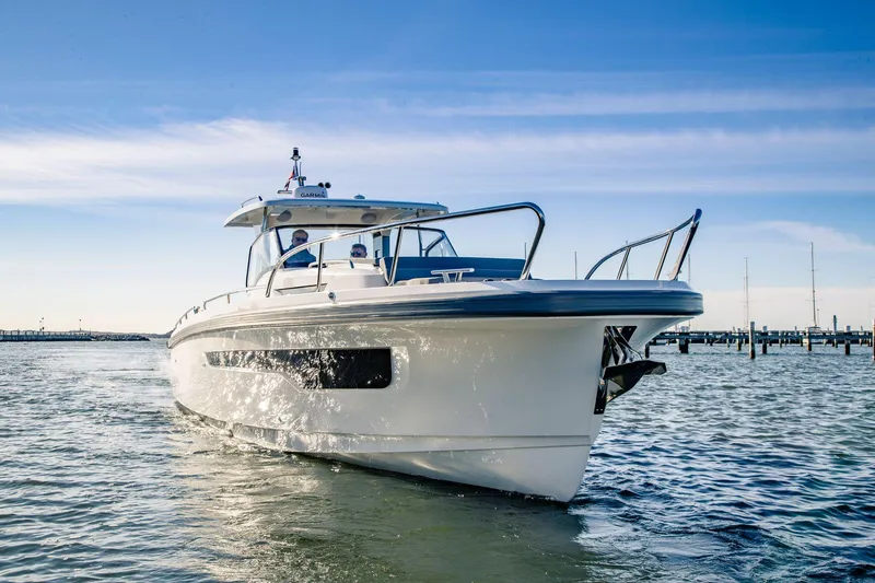 Slide: The Image of 2024 Nimbus Tender 11 boat cruising on calm waters under a clear blue sky. - 2