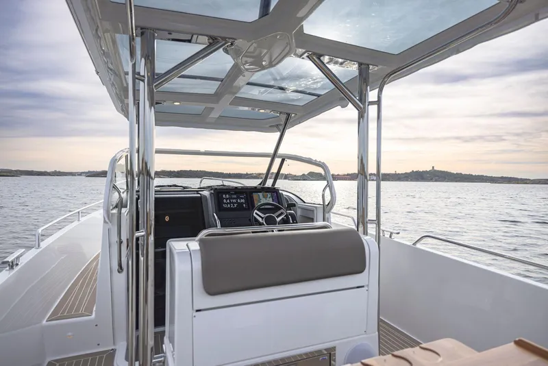 Slide: The Image of 2024 Nimbus Tender 9 boat interior with modern helm and panoramic water view. - 10