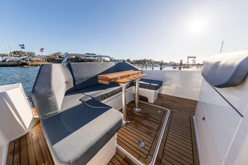 Slide: The Image of 2024 Nimbus Tender 9 boat interior with sleek seating and wooden flooring. - 11