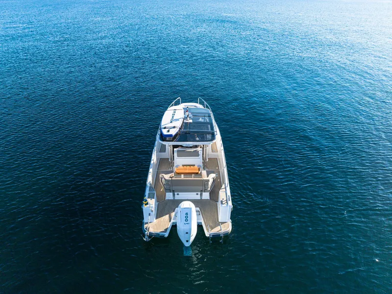 Slide: The Image of 2024 Nimbus Tender 9 boat on open water, aerial view. - 21