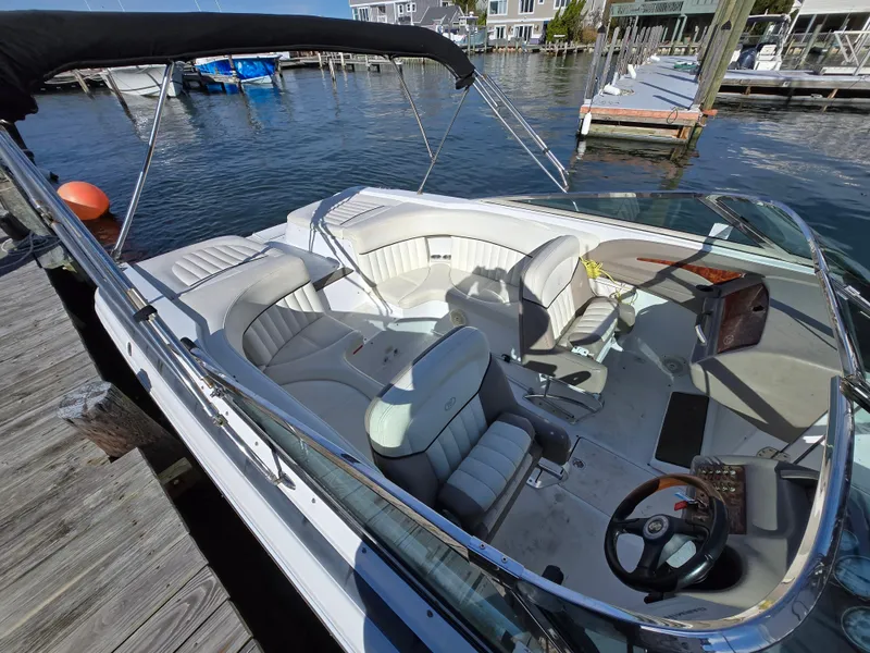 Slide: The Image of 2006 Cobalt 262 boat with white interior docked at a marina. - 10