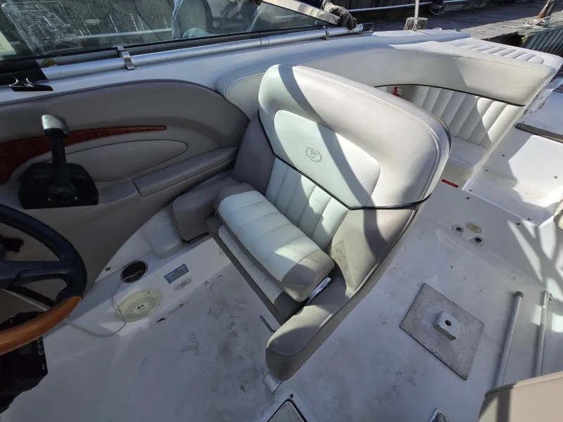 Slide: The Image of 2006 Cobalt 262 boat interior with gray leather seating and steering wheel. - 17
