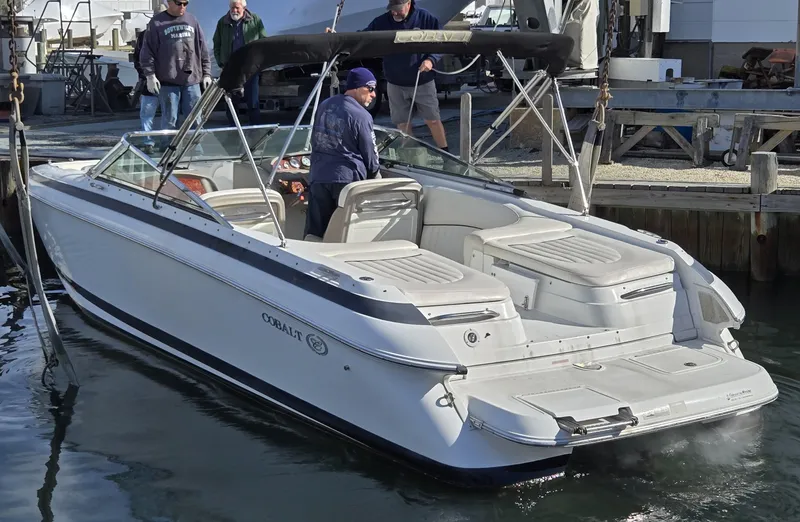 Slide: The Image of 2006 Cobalt 262 boat docked with passengers, featuring sleek design and spacious seating. - 24