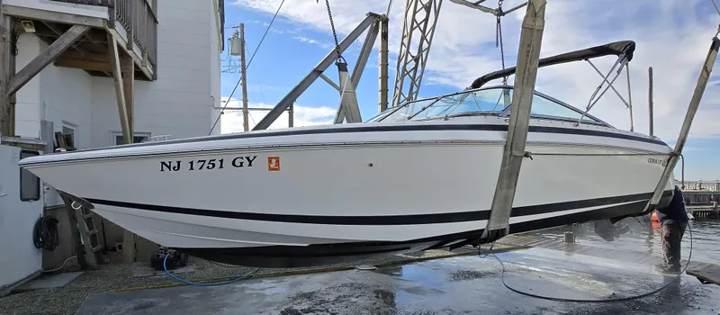 Slide: The Image of 2006 Cobalt 262 boat suspended on a lift, side view, with registration NJ 1751 GY. - 29