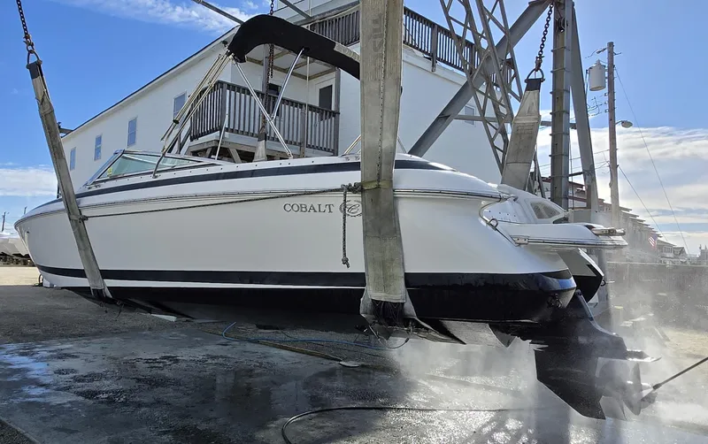Slide: The Image of 2006 Cobalt 262 boat being lifted for maintenance at a marina. - 30