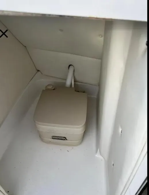 Slide: The Image of Portable toilet in 2006 Cobalt 262 boat compartment. - 33