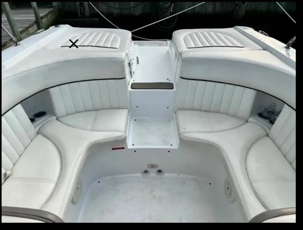 Slide: The Image of 2006 Cobalt 262 boat interior with white cushioned seating. - 5