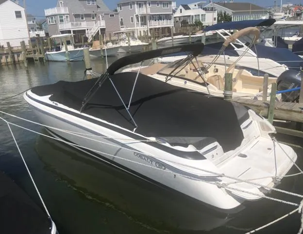 Slide: The Image of 2006 Cobalt 262 boat docked in a marina with protective cover. - 9