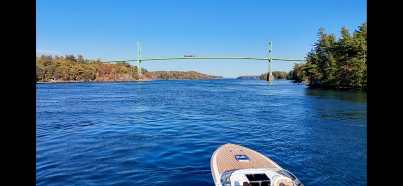 Slide: The Image of 2024 Comitti Venezia V28 cruising under a scenic bridge on a clear day. - 11