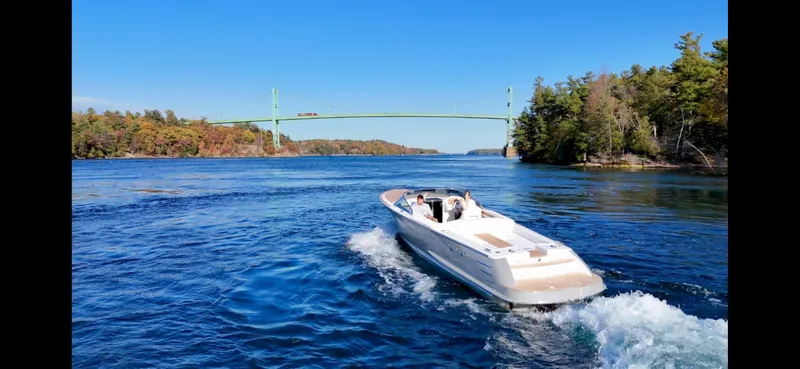 Slide: The Image of 2024 Comitti Venezia V28 cruising on a scenic river with a bridge and lush trees. - 12