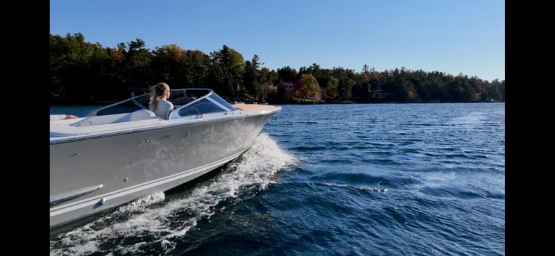 Slide: The Image of 2024 Comitti Venezia V28 cruising on a scenic lake with forested shoreline. - 23