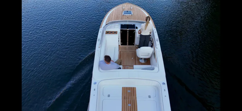 Slide: The Image of 2024 Comitti Venezia V28 luxury boat cruising on calm water, top view. - 3