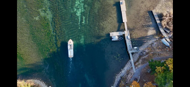 Slide: The Image of Aerial view of 2024 Comitti Venezia V28 boat near a dock on clear water. - 34