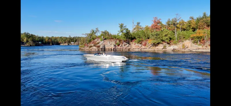 Slide: The Image of 2024 Comitti Venezia V28 boat cruising on a scenic river with autumn foliage. - 8