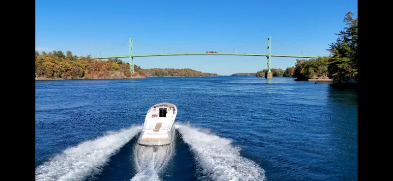 Slide: The Image of 2024 Comitti Venezia V28 cruising under a scenic bridge on a clear day. - 9