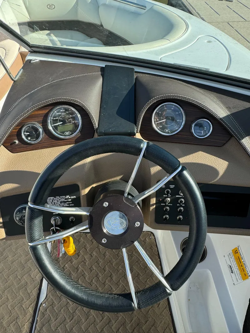 Slide: The Image of Steering wheel and dashboard of a 2015 Cobalt 220 boat. - 11