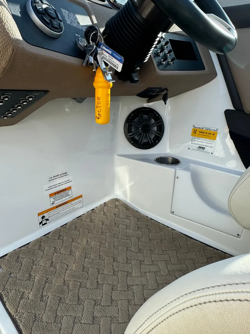 Slide: The Image of Interior of a 2015 Cobalt 220 boat showing steering wheel and dashboard controls. - 13