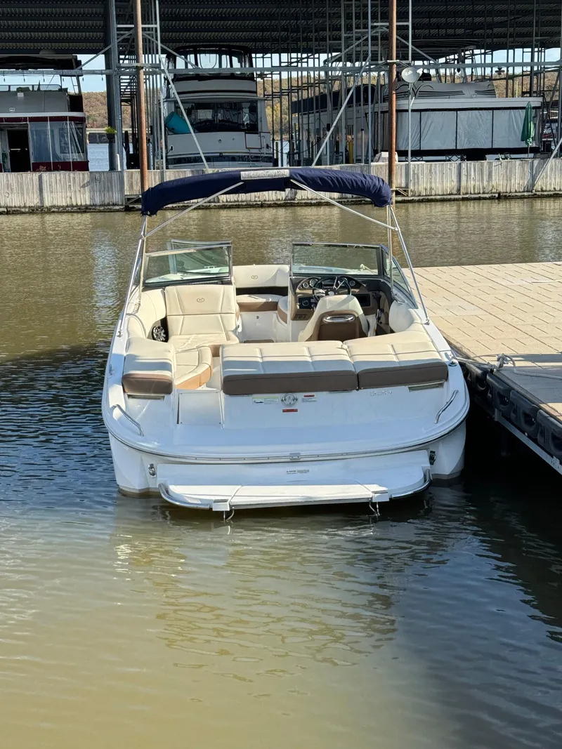 Slide: The Image of 2015 Cobalt 220 boat docked at marina, featuring spacious seating and sleek design. - 6