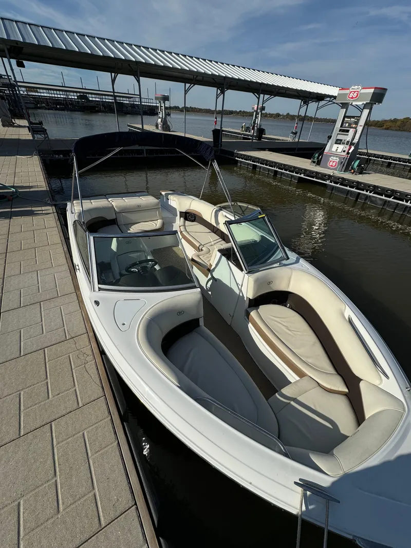 Slide: The Image of 2015 Cobalt 220 boat docked at marina with covered fuel station. - 8