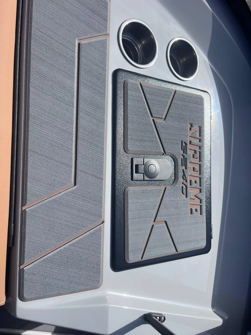 Slide: The Image of 2025 Supreme S240 boat deck with cup holders and textured surface. - 13